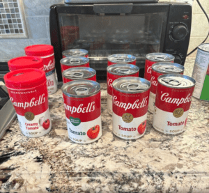 multiple cans of tomato soup on the kitchen counter. 